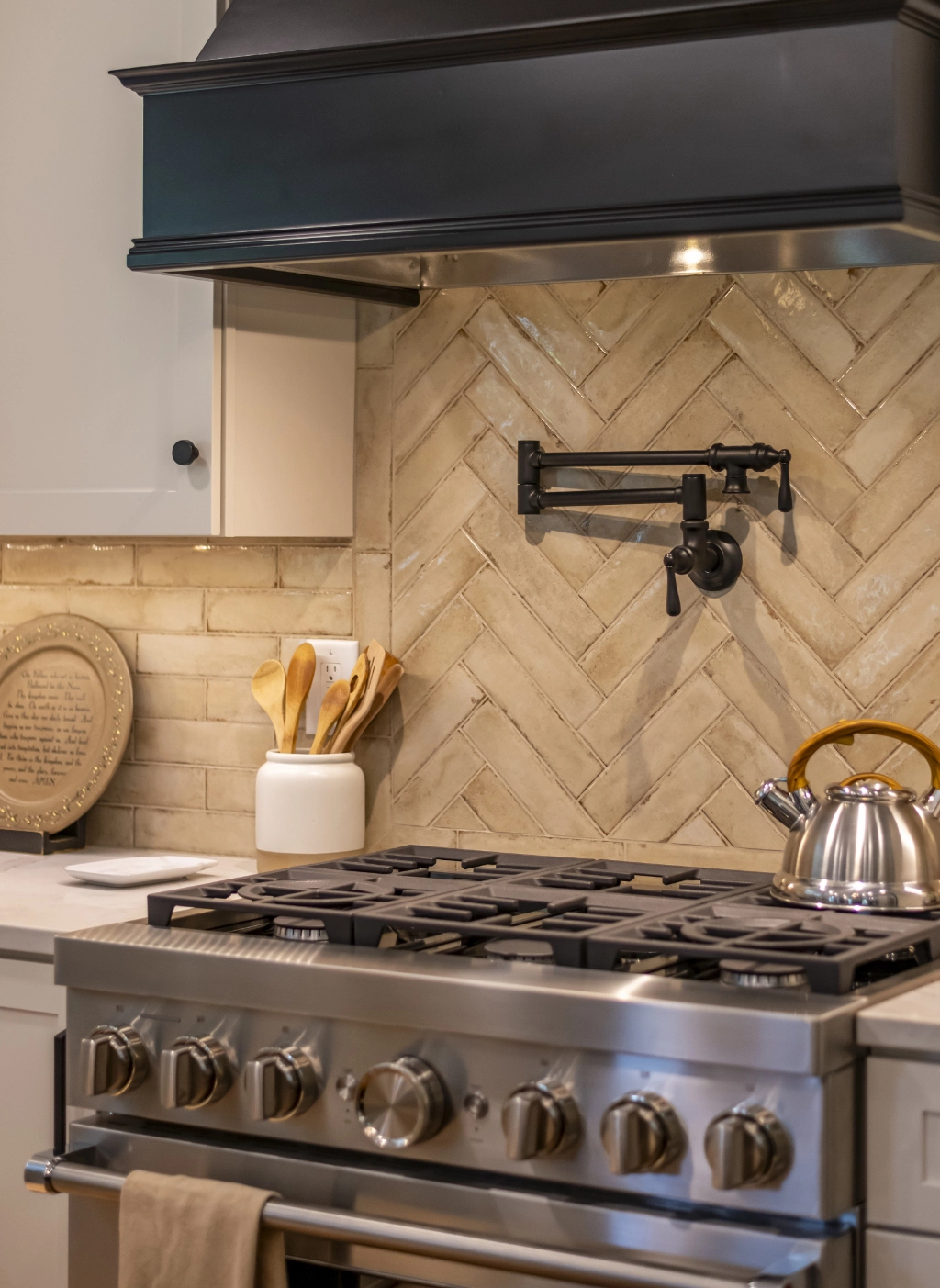 Residential kitchen with updated backsplash and stainless steel appliances.